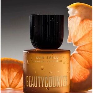 beautycounter Sun Spill Eau de Parfum in amber orange bottle with black cap